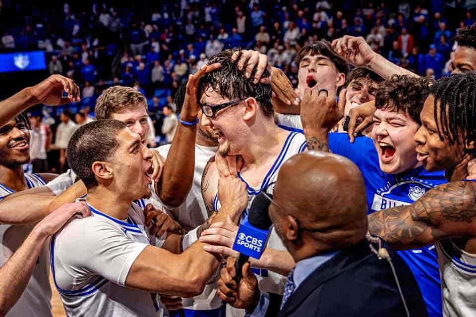 The SLU men's basketball team celerbrates on the court following a game during March Madness
