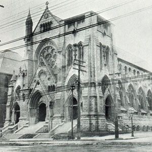 A photo of a steepleless St. Francis Xavier College Church. The steeple was completed in 1914.