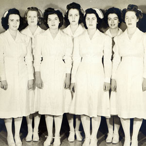 Nurses dressed in full uniform and hats circa 1928