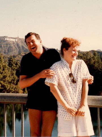 Marianne Muellerleile and husband Tom Norris with the Hollywood sign in background