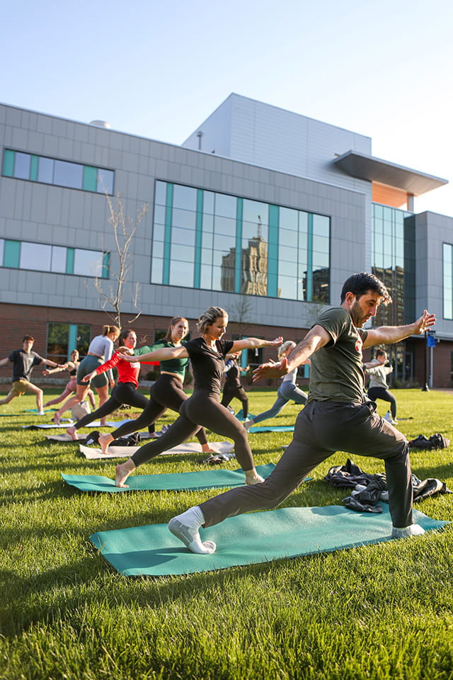 SLU community members practice yoga outdoors