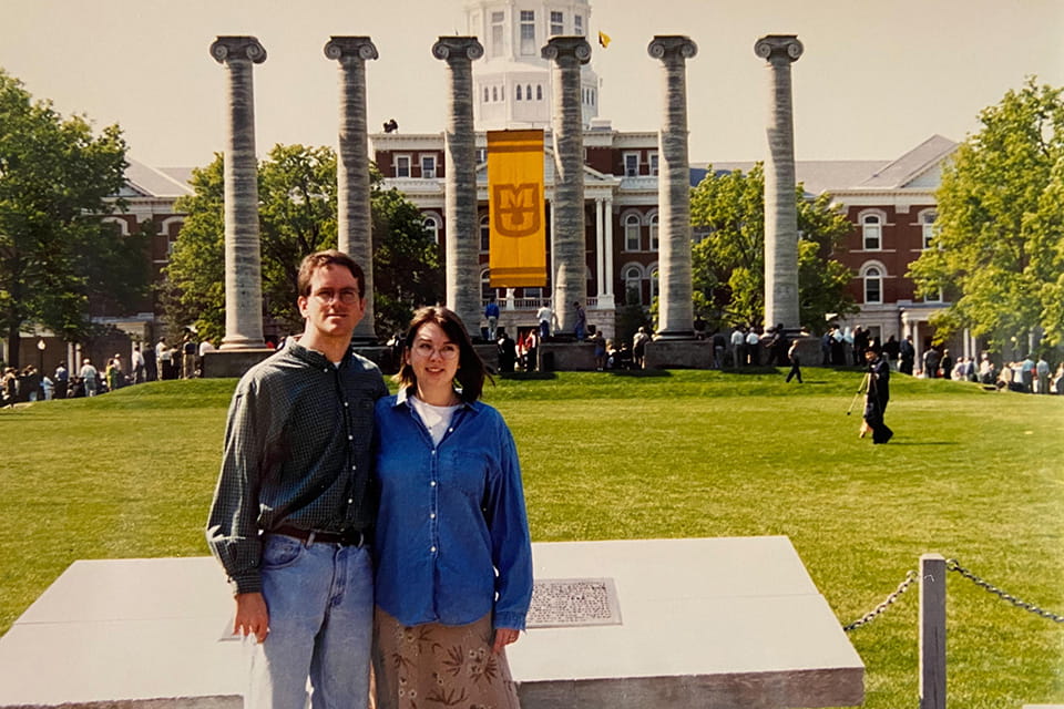 The Sowells pose in front of outdoor columns at the University of Missouri