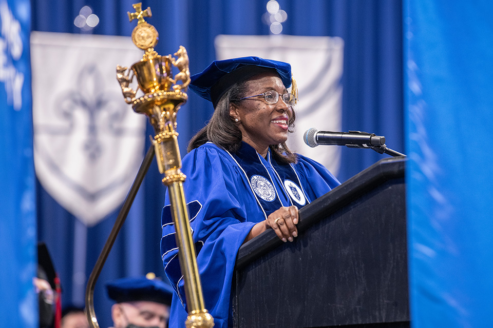 Tiffany Anderson in full academic regalia, addressing SLU's graduates