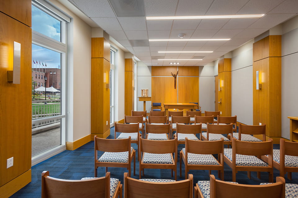 A chapel with rows of chairs looking toward the altar.