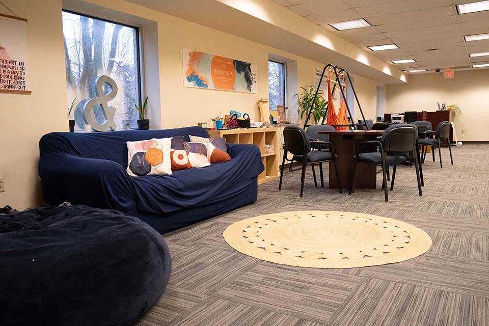 An room with comfortable couches, chairs and tables.